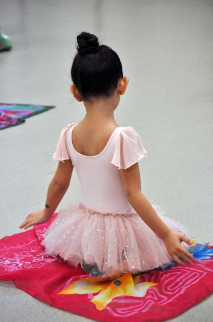 Photo of the back of a little girl in a ballet outfit