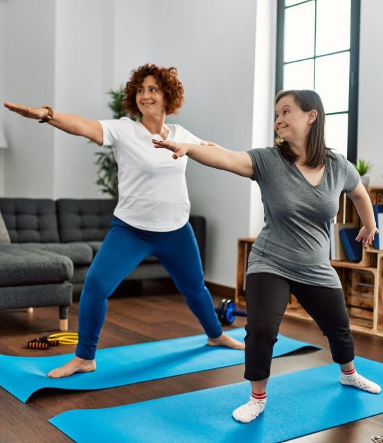 Two people stretching in Yoga type of movement