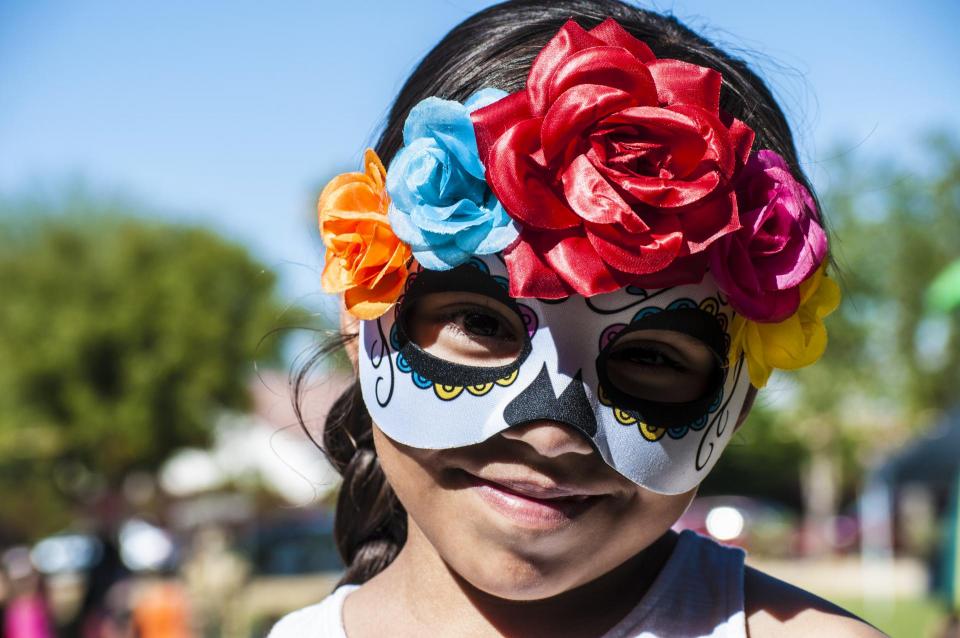 Girl wearing Dia De Los Muertos costume photo